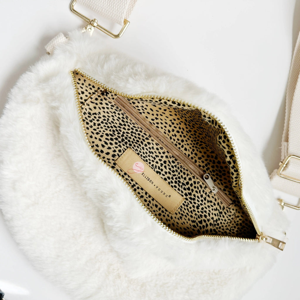 Kavon Buttery Bliss sling bag with gold hardware and custom lining, featuring a sleek, stylish design with adjustable strap.