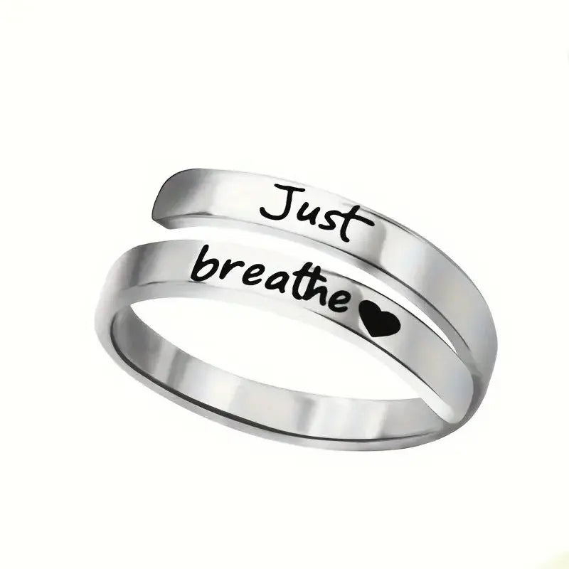 Stainless steel spiral heart ring engraved with "Just Breathe" by Kavon, silver jewelry featuring a unique heart design.