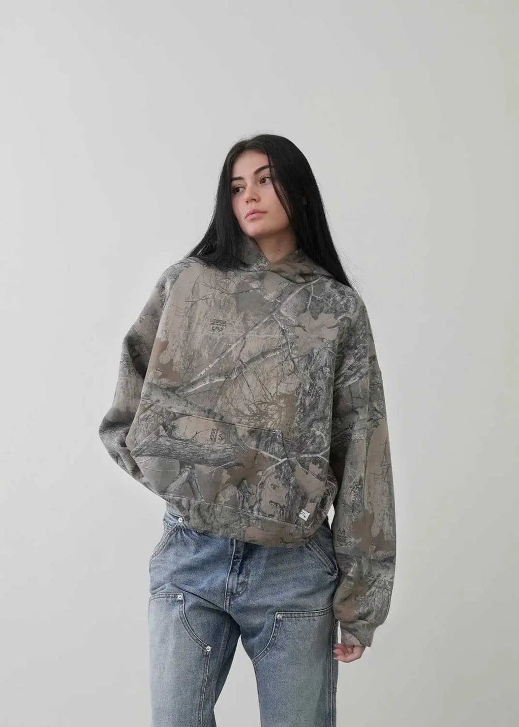 Kavon urban camo unisex oversized hooded sweatshirt with retro hip hop style, featuring a bold camouflage pattern and a relaxed fit.
